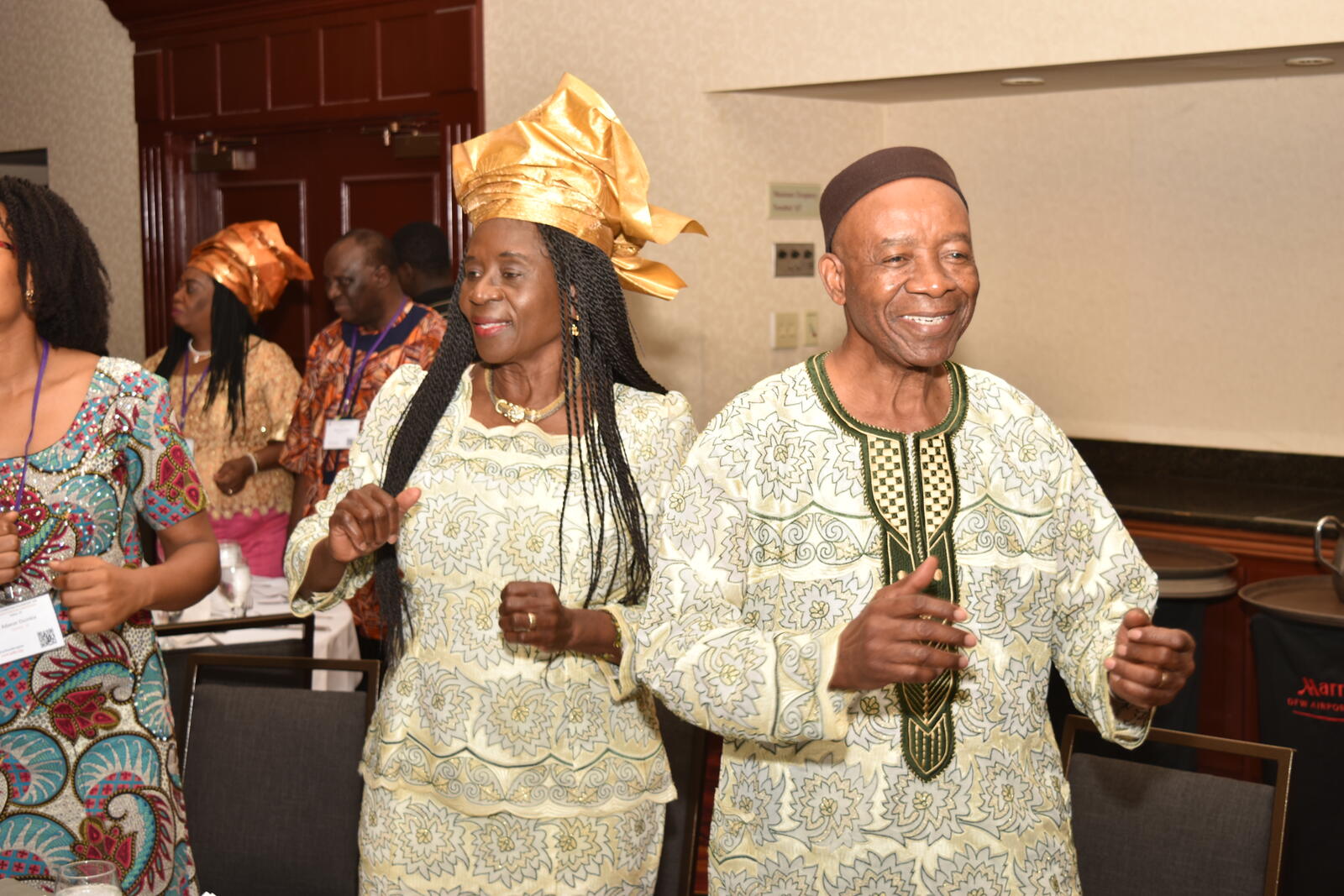 An older couple in traditional attire dancing