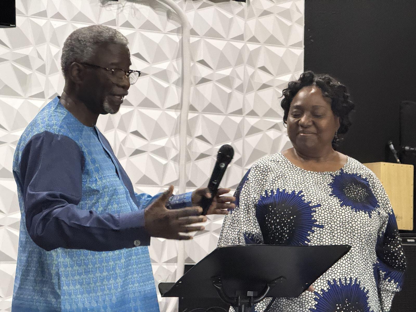 Two ACF Dallas elders in matching blue attire sharing at a gathering