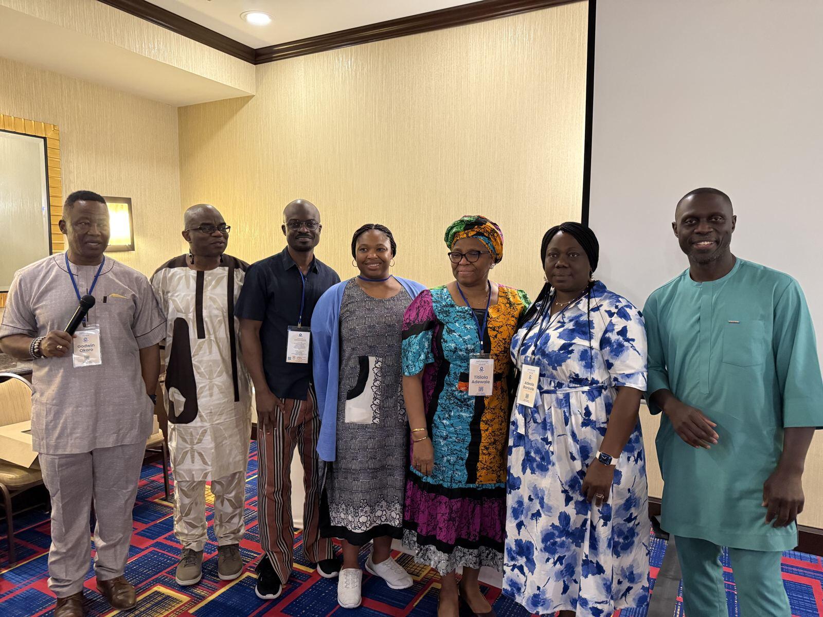 A group of ACF members standing together at a meeting
