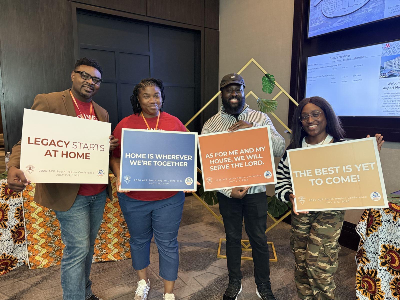 Four ACF Dallas members holding signs reading Legacy starts at home, Home is wherever we're together, As for me and my house we will serve the Lord, and The best is yet to come